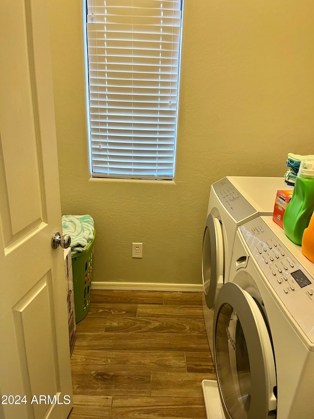 washroom featuring washing machine and clothes dryer and dark hardwood / wood-style floors