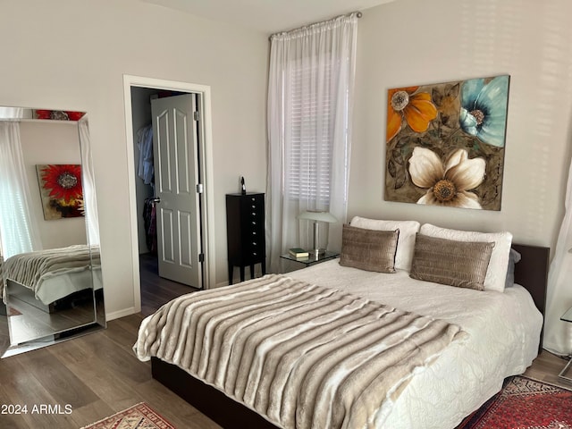 bedroom with dark hardwood / wood-style flooring