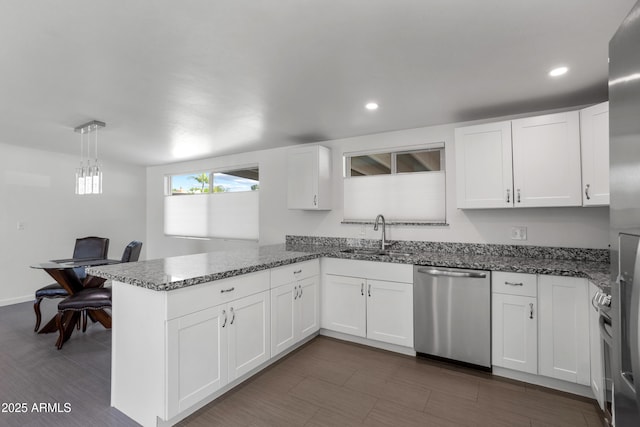 8425 E Hawthorne St, Tucson, AZ 85710 - kitchen with dishwasher, a sink, a peninsula, white cabinetry, and dark stone counters