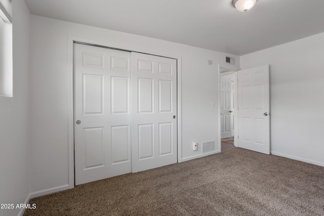 8425 E Hawthorne St, Tucson, AZ 85710 - unfurnished bedroom with carpet flooring, a closet, and baseboards