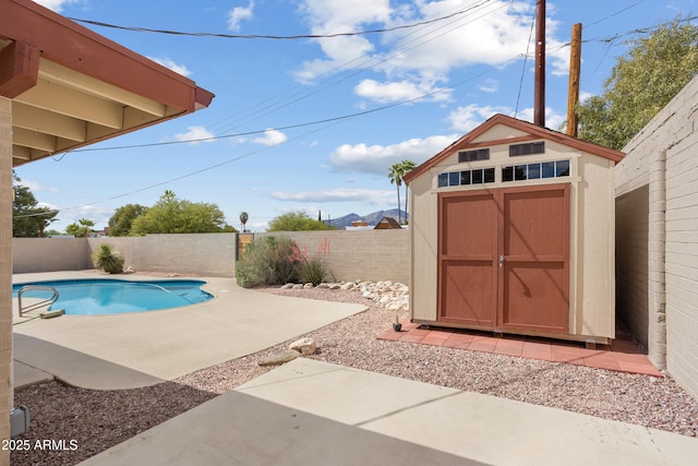 8425 E Hawthorne St, Tucson, AZ 85710 - view of pool featuring a storage shed, a fenced backyard, a patio area, and an outbuilding