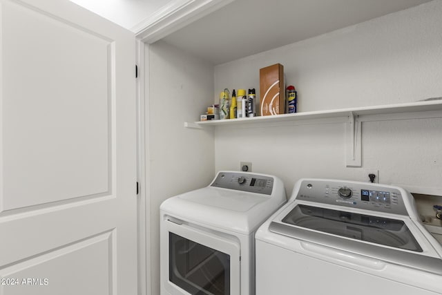 clothes washing area with independent washer and dryer and laundry area