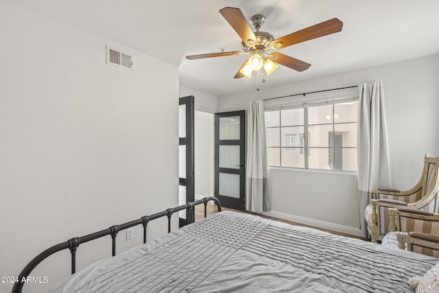 bedroom featuring ceiling fan, baseboards, and visible vents