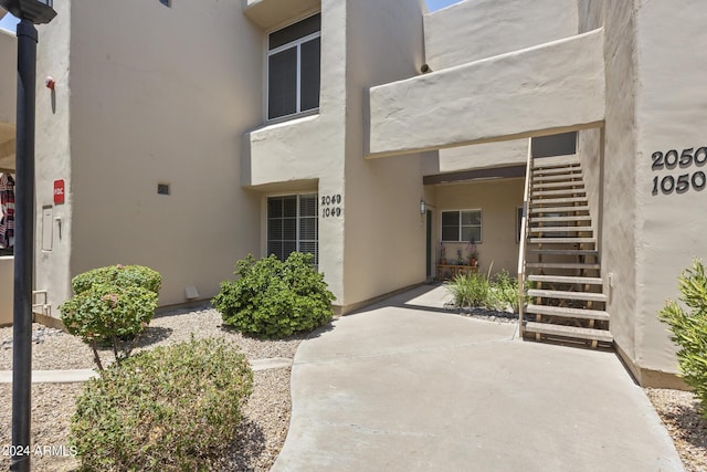 entrance to property with a patio and stucco siding