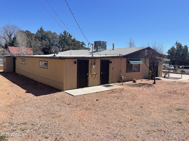 rear view of property featuring cooling unit