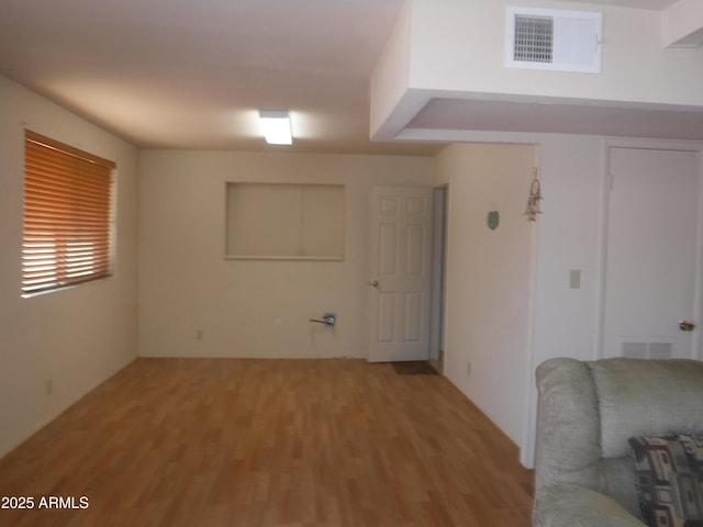 basement with hardwood / wood-style floors