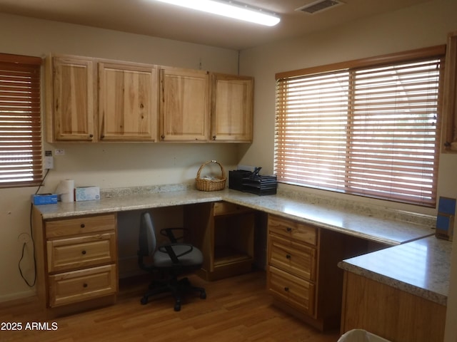 office area featuring light hardwood / wood-style flooring and built in desk