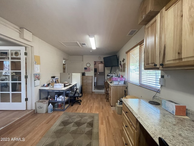 kitchen featuring light stone countertops and light hardwood / wood-style floors