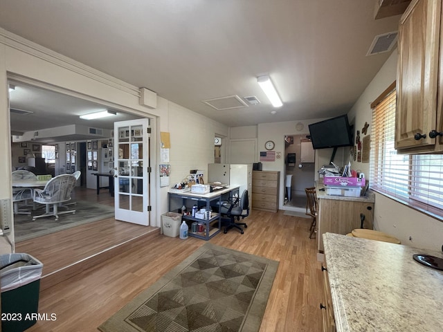 interior space with french doors and light hardwood / wood-style flooring