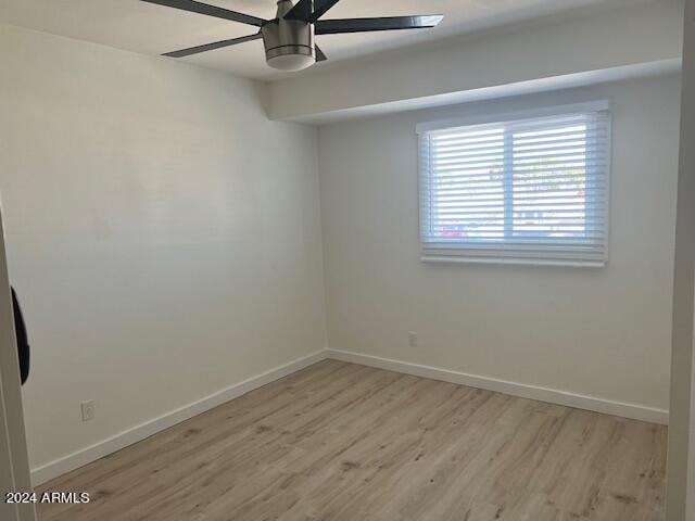 spare room featuring light hardwood / wood-style flooring and ceiling fan