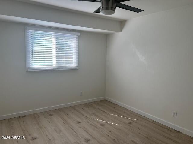 spare room with light hardwood / wood-style floors and ceiling fan