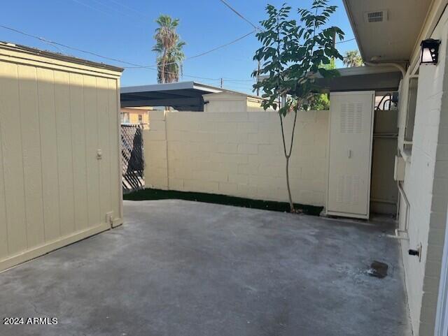 view of patio with a storage shed