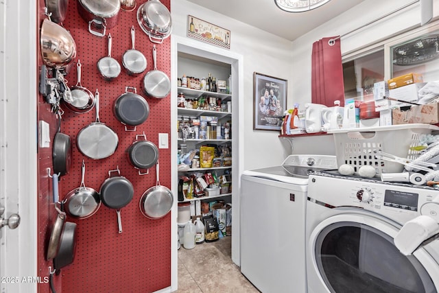 laundry room with washing machine and dryer and light tile patterned floors