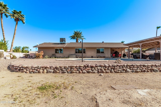 rear view of property with cooling unit, a patio area, and a pergola