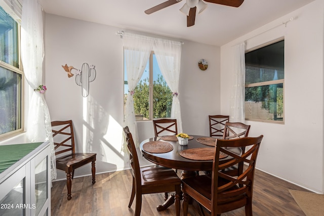 dining space with ceiling fan and dark hardwood / wood-style floors