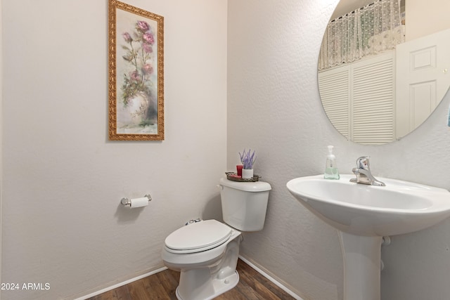 bathroom with toilet and wood-type flooring