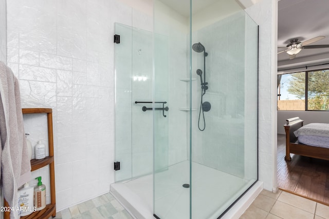 bathroom with a shower with door, ceiling fan, and wood-type flooring