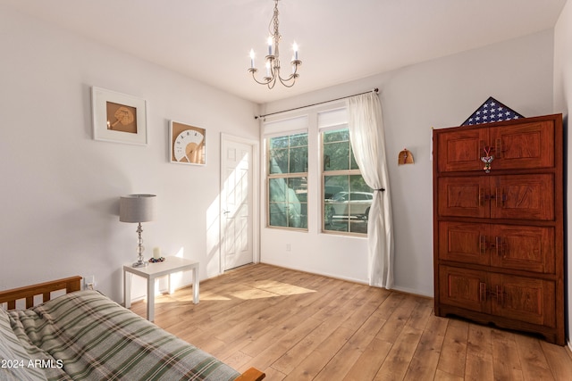 sitting room with light hardwood / wood-style floors and a chandelier