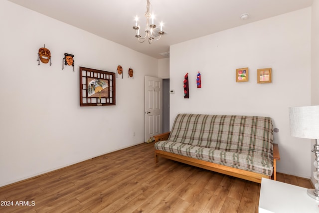 living area with hardwood / wood-style floors and a chandelier