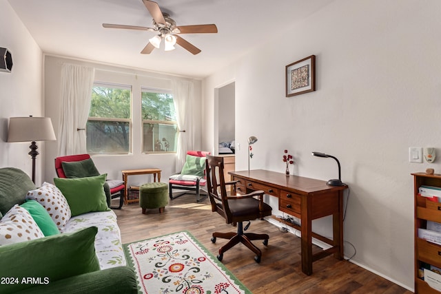 home office with wood-type flooring and ceiling fan