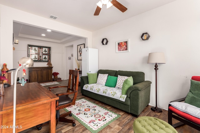 office area with ceiling fan, a tray ceiling, and dark hardwood / wood-style floors