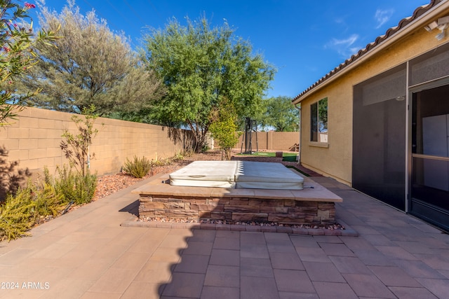 view of patio with a hot tub