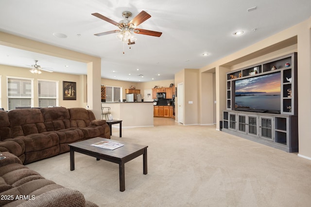 living room with built in features, recessed lighting, light carpet, and baseboards