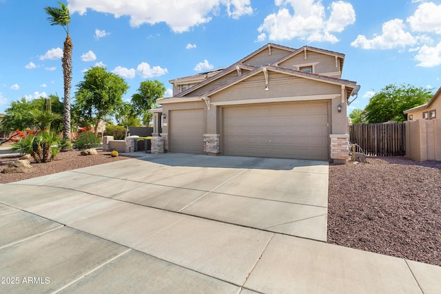 craftsman-style house featuring driveway, stone siding, an attached garage, fence, and stucco siding