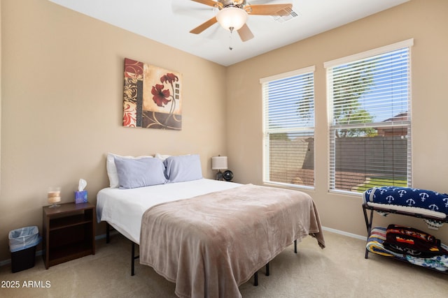 carpeted bedroom featuring visible vents, baseboards, and ceiling fan