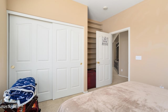 bedroom with a closet and light colored carpet