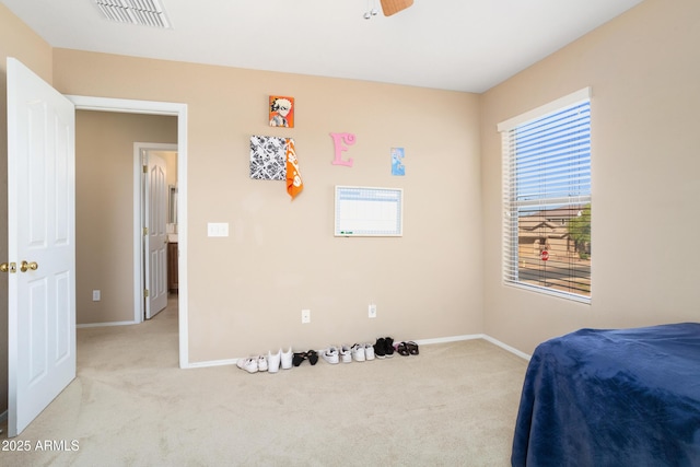 bedroom featuring carpet flooring, ceiling fan, visible vents, and baseboards