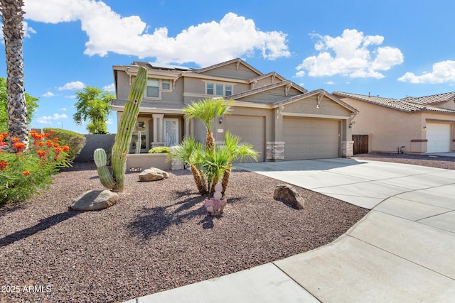 view of front of property with solar panels, concrete driveway, stone siding, an attached garage, and stucco siding