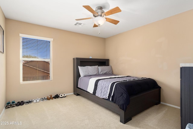 carpeted bedroom featuring baseboards, visible vents, and a ceiling fan