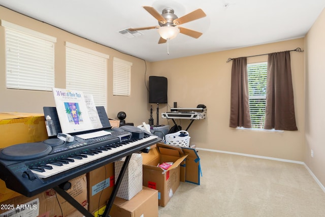 miscellaneous room featuring carpet, visible vents, ceiling fan, and baseboards