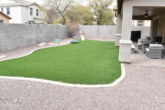 view of yard with a patio area, ceiling fan, and a fenced backyard