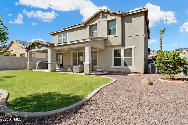 rear view of house with ceiling fan, a fenced backyard, outdoor lounge area, stucco siding, and a patio area