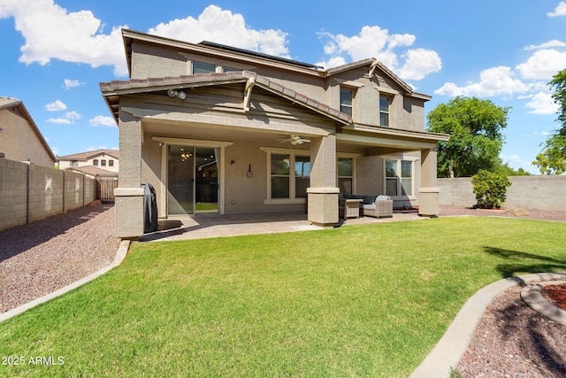 rear view of house with a patio area, a fenced backyard, a ceiling fan, and stucco siding