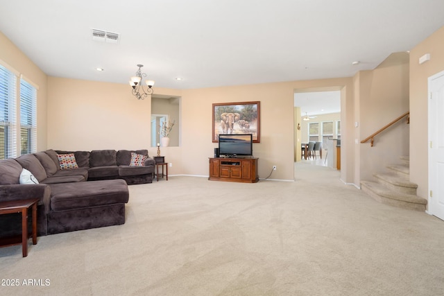 living room featuring light carpet, baseboards, visible vents, an inviting chandelier, and stairs