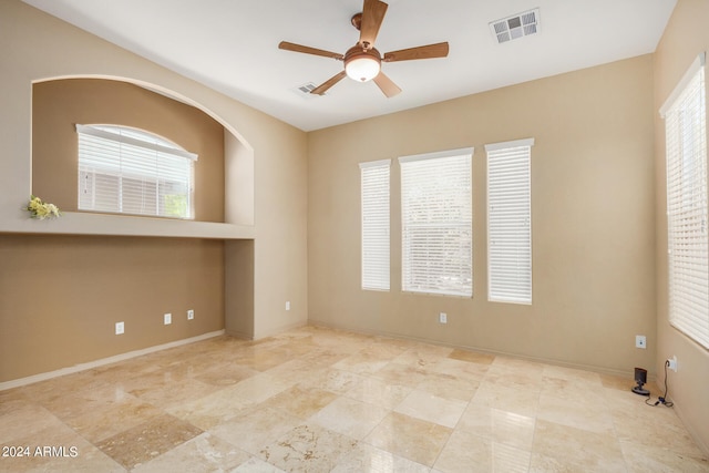 unfurnished room with ceiling fan