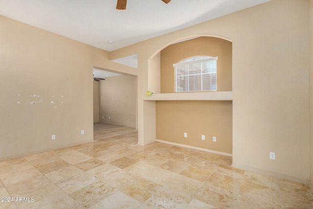 unfurnished room with ceiling fan