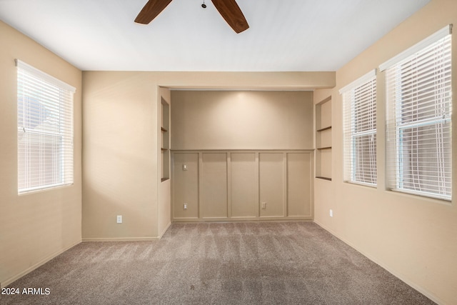 spare room featuring light carpet and ceiling fan