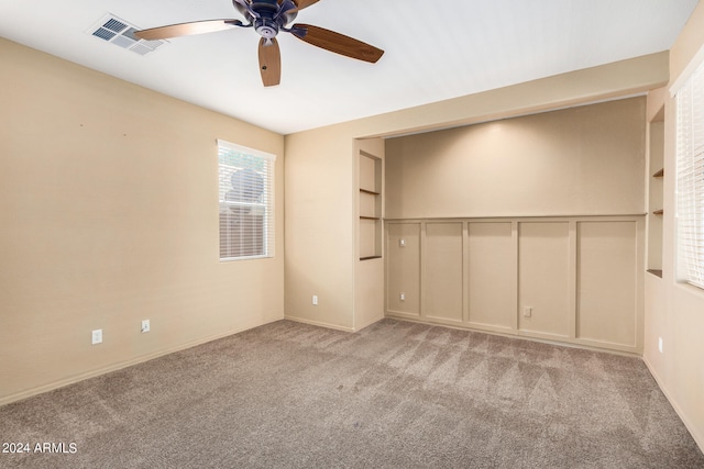 carpeted empty room with ceiling fan