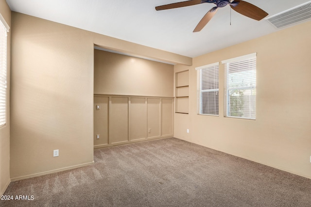 unfurnished room featuring light carpet and ceiling fan