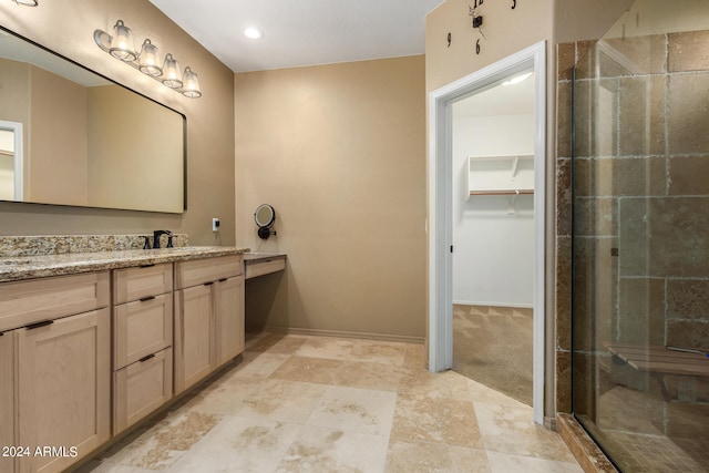 bathroom with walk in shower and vanity