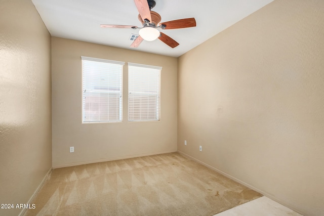 carpeted empty room featuring ceiling fan