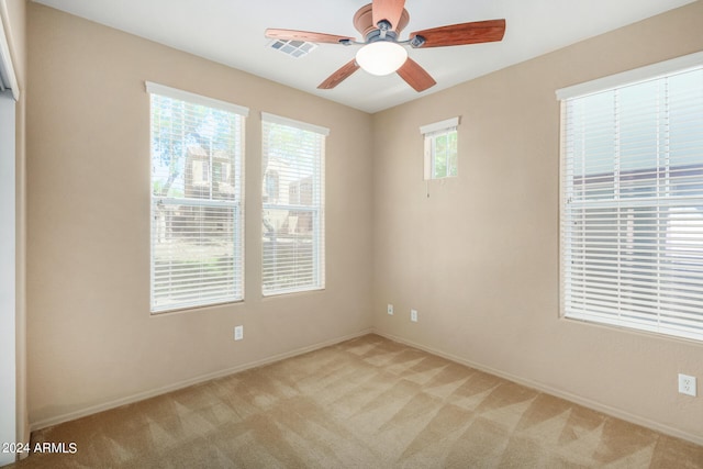 spare room with light carpet and ceiling fan