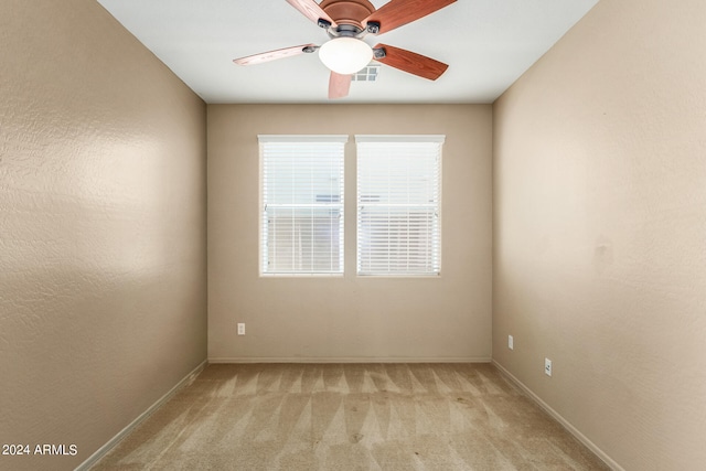 unfurnished room featuring light carpet and ceiling fan