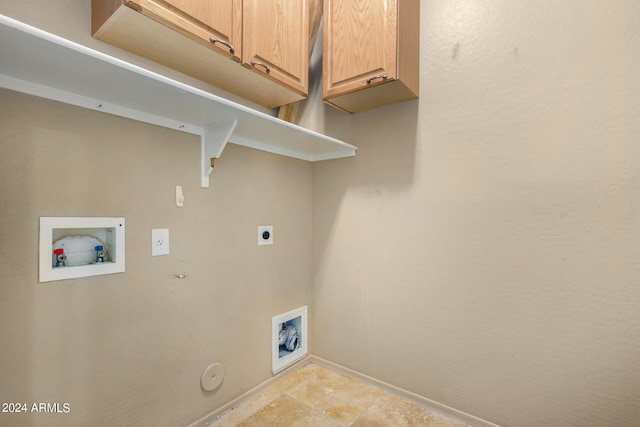 clothes washing area with cabinets, hookup for an electric dryer, hookup for a gas dryer, and hookup for a washing machine