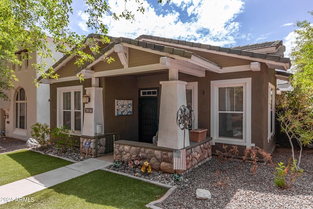 craftsman-style home with a front yard