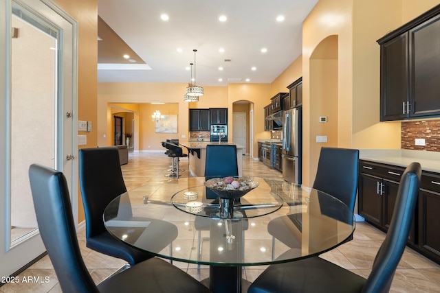 2285 E Mead Dr, Gilbert, AZ 85298 - dining room featuring arched walkways, recessed lighting, a chandelier, and light tile patterned floors